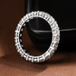 Anel inteiro cravejado com moissanite em prata 925 exposto em fundo elegante 1

